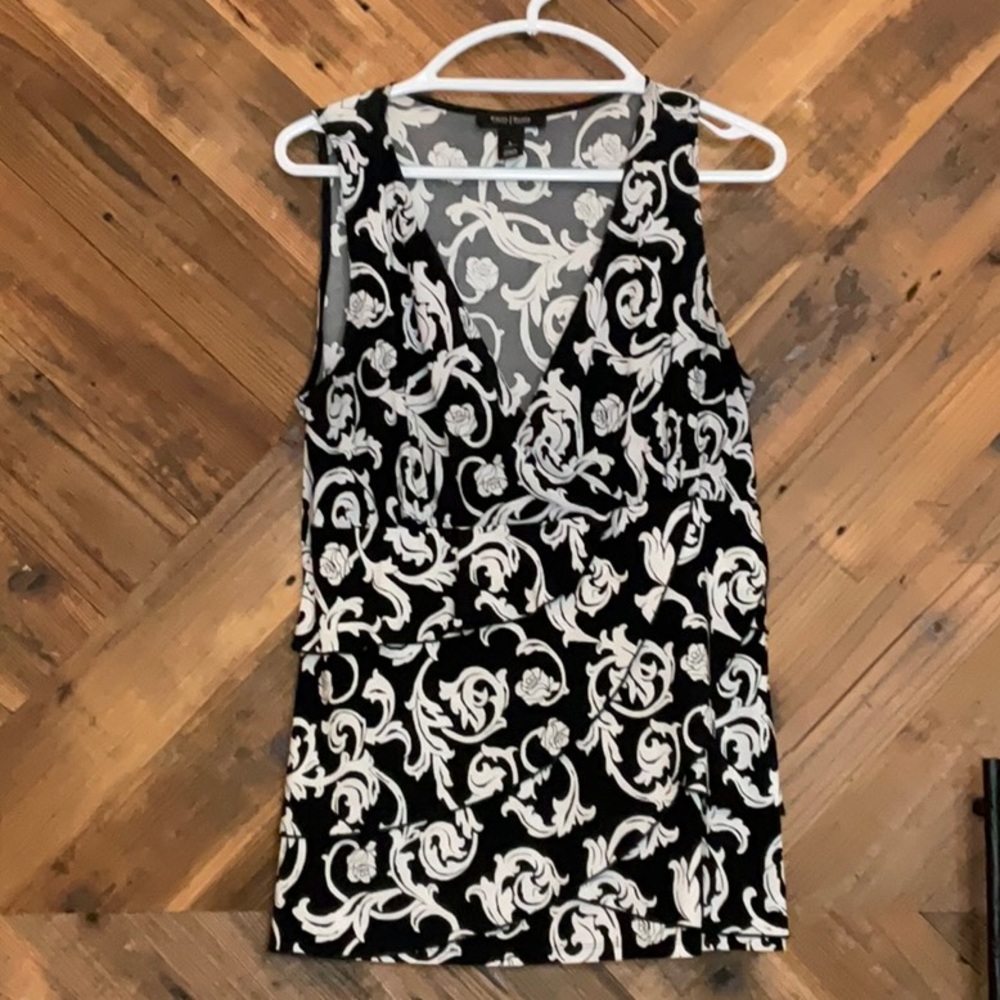 Sleeveless White House Black Market blouse. Black with white floral pattern.